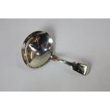 A George III silver caddy spoon with oval bowl and engraved initialled fiddle pattern handle,