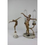 An Art Deco style figural table lamp modelled as a gold painted figure with arms outstretched, and