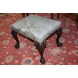 A blue upholstered rectangular footstool on carved mahogany shell capped cabriole legs