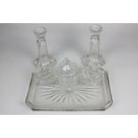 A mid 20th century clear glass dressing table set including a pair of candlesticks, an octagonal jar