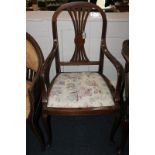 An Edwardian inlaid mahogany elbow chair with drop in upholstered seat on tapered legs