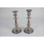 A pair of silver plated candlesticks with vase sconces and removable nozzles, on baluster stems