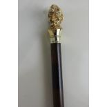 An Elizabeth II silver gilt mounted coco bola walking stick modelled as Punch, maker KC,