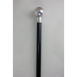 An Elizabeth II silver mounted ebony walking stick modelled as a globe, maker KC, Birmingham 2000,