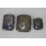 Three various George V silver cigarette cases with engraved initials, largest 9cm