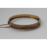 A ruby bangle channel set with 23 square cut stones