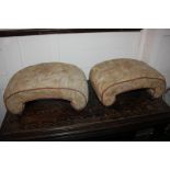 A pair of Victorian fully upholstered footstools of curved form