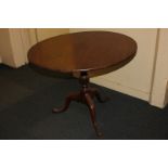 A George III mahogany circular tilt-top tea table on baluster stem and tripod base, 90cm