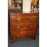 A Regency flame mahogany bachelors chest of three long drawers with brushing slide on bracket feet