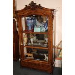 A Victorian walnut display cabinet with scrolling foliate carved surmount and pierced sides, large