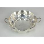 An Edward VII silver circular two-handled bowl, scallop border embossed with flowers, maker