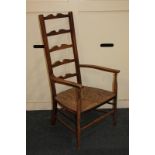 A rush seated ladderback elbow chair