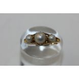 A pearl three bead ring in 18ct gold