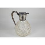 An Edward VII silver mounted cut glass claret jug with hinged lid and scroll handle, maker Atkin