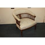 An Edwardian inlaid mahogany framed tub chair with upholstered back rail and seat, on slatted
