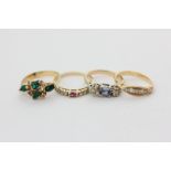 A sapphire and diamond three-stone ring and three other gem set rings
