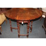 A Queen Anne walnut oval gateleg table, on bobbin turned legs, 112cm fully open