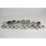 A pair of George V silver napkin rings with pierced design, a set of five silver napkin rings, and