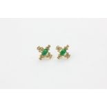 A pair of emerald and diamond ear studs, the oval cuts within small diamond borders, in yellow gold