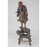A Chinese carved gnarled wood figure of a sage standing on a structure, 59cm, (a/f)
