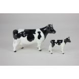 A Beswick model of a Friesian cow, Ch. 'Claybury Leegwater', black and white gloss, 12cm, and a