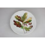 A Clarice Cliff 'Forest' Newport Pottery plate decorated with an oak leaf, 25cm