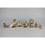 A collection of six Goebel Hummel figures including Girl with Geese, Daddy's Girls, and Little