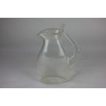A studio glass jug signed Newell, of simplistic clear glass form