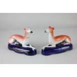 A pair of Staffordshire quill holders in the form of greyhounds, 12.5cm