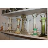 A collection of twelve 19th century and later candlesticks in porcelain, composite and glass