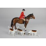 A Beswick huntsman on brown gloss horse, 21cm, and three hounds (a/f)