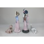 A Lladro porcelain figure of a geisha, boxed, a Lladro figure of a cat, and two Nao figures of a