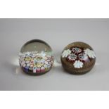 Two millefiori glass paperweights, one polychrome, the other with brown glitter design, largest