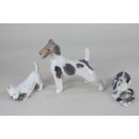 Three Royal Copenhagen porcelain models of dogs, including a fox terrier, a hound with a game