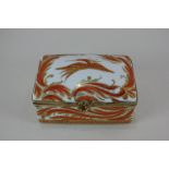 A 19th century Sèvres style gilt metal mounted porcelain trinket box depicting a bird with orange