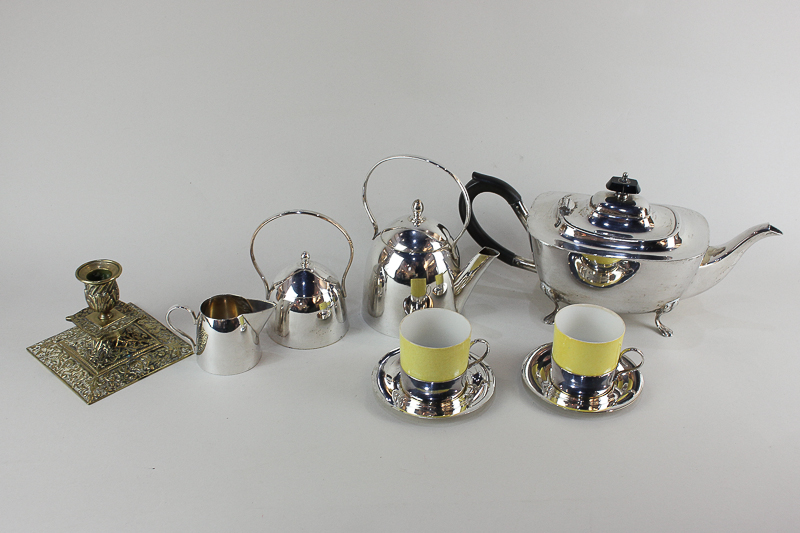 A plated tea set comprising tea pot, milk jug, sugar bowl, and two yellow porcelain cups with plated