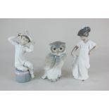 A Lladro porcelain figure of a girl wearing a hat, two Nao porcelain figures of an owl and a girl in