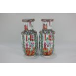 A pair of Chinese Cantonese porcelain vases depicting seated figures (one a/f) 24.5cm high