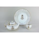 A 19th century Sevres porcelain teapot, plate and small bowl, all bearing the monogram of Napoleon