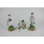 A pair of Dresden porcelain figures of fruit and flower sellers in 18th century attire, cross swords