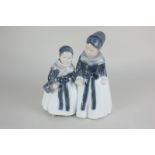 A Royal Copenhagen porcelain figure of two young girls holding hands, 18.5cm