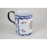 A Chinese export blue and white porcelain mug decorated with polychrome floral sprays and gilt
