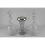 A George V silver mounted moulded glass vase, together with a pair of cut glass decanters with