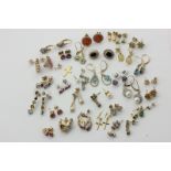 Twenty-nine pairs of 9ct gold and gem set earrings and a few singles