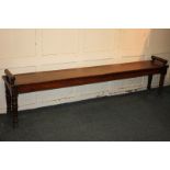 A Victorian long bench, with cylindrical end supports, on turned baluster legs, 205cm
