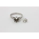 A diamond single stone ring, the round brilliant cut stone eight-claw set with three small stones to
