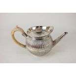 A George III silver teapot of reeded globular form, marks worn, London 1794, 26.5oz gross