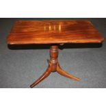 A 19th century mahogany side table with rectangular shaped top and turned baluster stem, on outswept