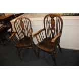 A pair of Windsor armchairs with pierced wheel backs, solid seats, on turned legs