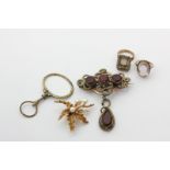 Two 9ct gold gem set dress rings, a 9ct gold and pearl leaf brooch, a quizzing glass, and a paste